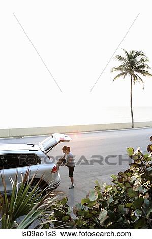 "Mature woman tying trainer laces on car boot, Palm Beach, Florida, USA" View Large Photo Image Stock Image - "Mature woman tying trainer laces on car boot, Palm Beach, Florida, USA". Fotosearch