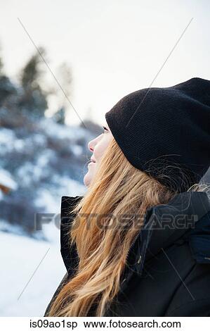 Mid adult woman in knit hat gazing up at snowy landscape View Large Photo Image Stock Photography - Mid adult woman in knit hat gazing up at snowy landscape. Fotosearch