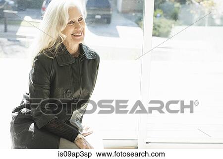"Portrait of a senior woman wearing a leather jacket, smiling" View Large Photo Image Stock Photography - "Portrait of a senior woman wearing a leather jacket, smiling". Fotosearch