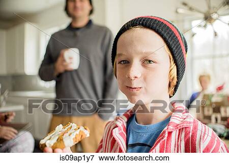 Portrait of boy eating cake in kitchen View Large Photo Image Stock Photo - Portrait of boy eating cake in kitchen. Fotosearch