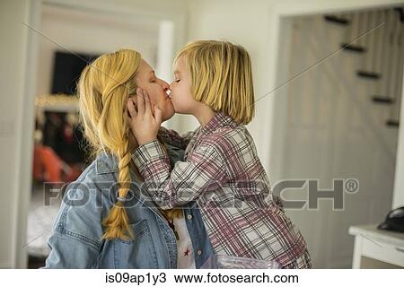 Portrait of boy kissing his mother in kitchen View Large Photo Image Stock Image - Portrait of boy kissing his mother in kitchen. Fotosearch