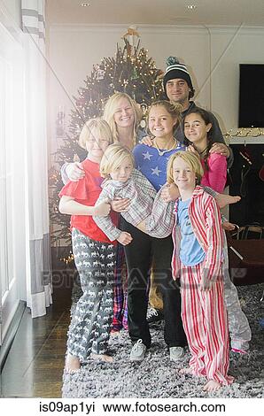 Portrait of family adults and children in front of christmas tree View Large Photo Image Stock Image - Portrait of family adults and children in front of christmas tree. Fotosearch