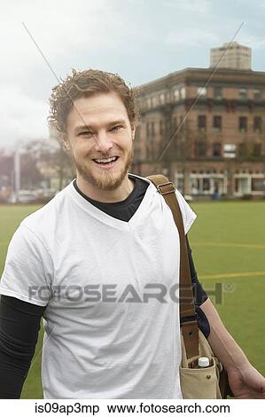 Portrait of mid adult male soccer player carrying gym bag on soccer pitch View Large Photo Image Stock Photography - Portrait of mid adult male soccer player carrying gym bag on soccer pitch. Fotosearch