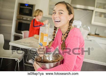 Portrait of teenage girl with mixing bowl in kitchen View Large Photo Image Stock Image - Portrait of teenage girl with mixing bowl in kitchen. Fotosearch