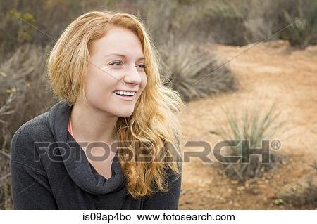 Picture - Portrait of young female hiker in landscape. Fotosearch