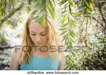Stock Photo - Portrait of young female hiker on riverside. Fotosearch