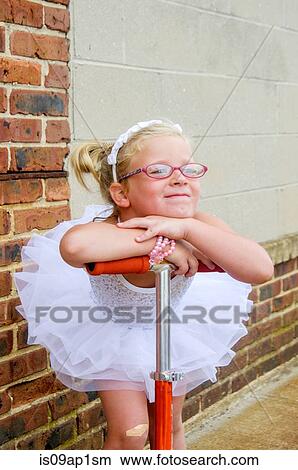 Portrait of young girl wearing tutu leaning on scooter handle View Large Photo Image Picture - Portrait of young girl wearing tutu leaning on scooter handle. Fotosearch