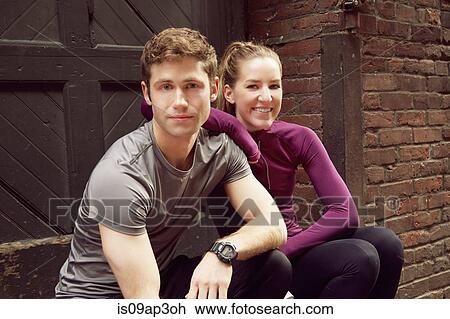 Portrait of young male and female runners sitting on alley step View Large Photo Image Stock Image - Portrait of young male and female runners sitting on alley step. Fotosearch