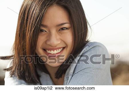 "Portrait of young woman, smiling, outdoors" View Large Photo Image Stock Image - "Portrait of young woman, smiling, outdoors". Fotosearch