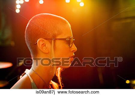 Stock Image - "Profile of punk girl, wearing black rimmed eyeglasses". Fotosearch