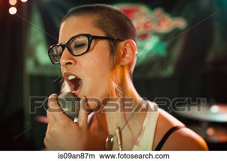 Punk girl singing into microphone View Large Photo Image Picture - Punk girl singing into microphone. Fotosearch