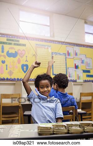 Pupils raising hands in classroom View Large Photo Image Stock Image - Pupils raising hands in classroom. Fotosearch
