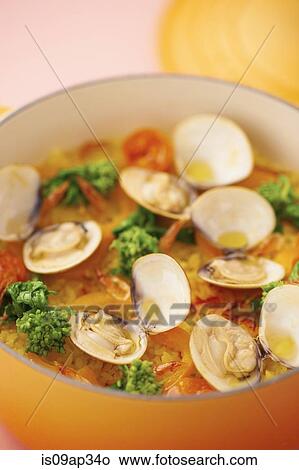 Picture - "Rice with meat, seafood and vegetables in cast iron cookware". Fotosearch