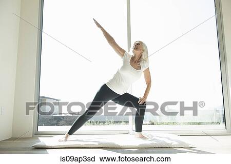 Senior Woman In Yoga Pose Arm Raised Stock Image Is09ap3sd