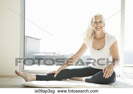 Stock Image - Senior woman stretching leg. Fotosearch