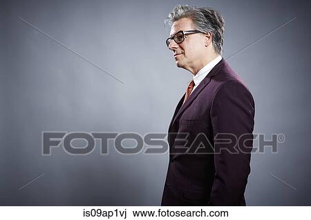 Stock Image - Side view studio portrait of businessman. Fotosearch