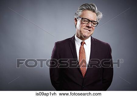 Studio portrait of businessman biting his lip View Large Photo Image Stock Image - Studio portrait of businessman biting his lip. Fotosearch