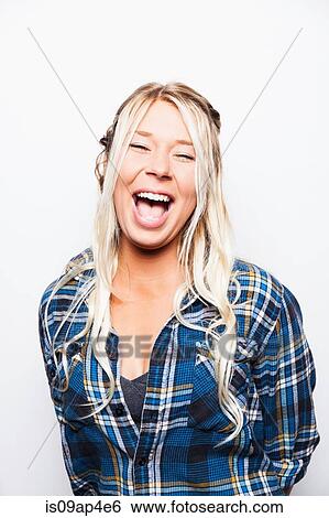 Stock Photograph - Studio portrait of laughing young woman with long blond hair. Fotosearch