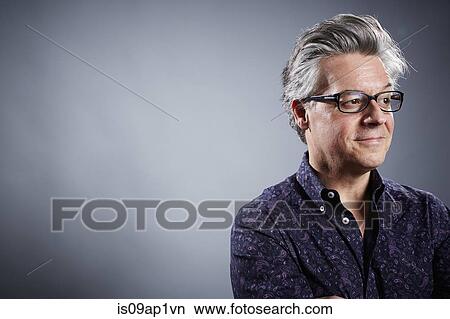 Picture - Studio portrait of mature businessman looking away. Fotosearch