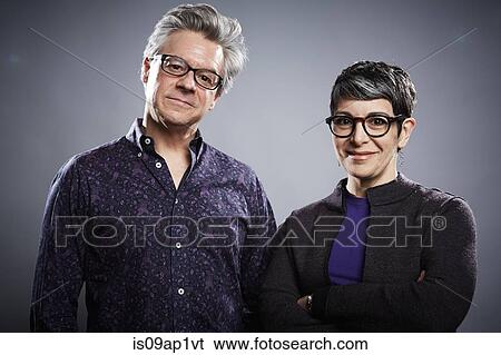Studio portrait of mature businessman and woman View Large Photo Image Stock Photograph - Studio portrait of mature businessman and woman. Fotosearch