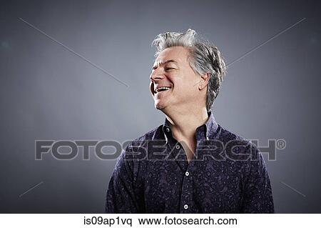 Stock Photography - Studio portrait of mature businessman laughing. Fotosearch