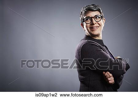 Studio portrait of mature businesswoman looking over her shoulder View Large Photo Image Stock Image - Studio portrait of mature businesswoman looking over her shoulder. Fotosearch