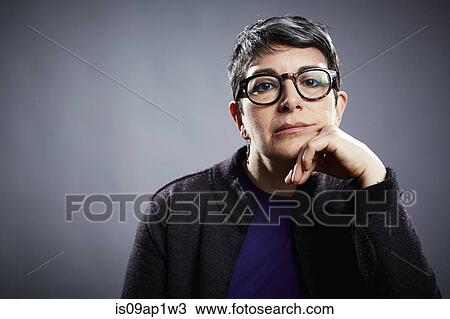 Studio portrait of mature businesswoman with chin on hand View Large Photo Image Stock Image - Studio portrait of mature businesswoman with chin on hand. Fotosearch