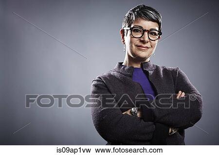 Stock Photo - Studio portrait of mature businesswoman with arms folded. Fotosearch