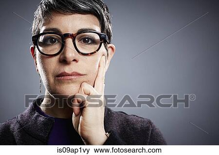 Studio portrait of mature businesswoman hand on cheek View Large Photo Image Stock Photo - Studio portrait of mature businesswoman hand on cheek. Fotosearch