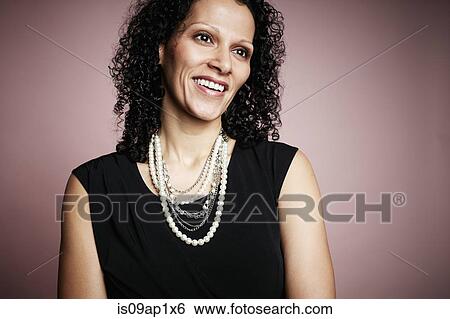 Stock Photograph - Studio portrait of smiling mature woman. Fotosearch