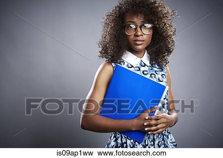 Studio portrait of young female student with notebook View Large Photo Image Stock Photo - Studio portrait of young female student with notebook. Fotosearch
