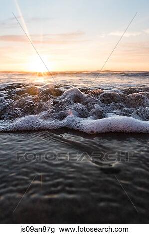 "Sunset over sea, tide coming in, close-up" View Large Photo Image Stock Image - "Sunset over sea, tide coming in, close-up". Fotosearch