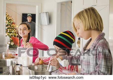 Teenage girl and brothers baking in kitchen View Large Photo Image Stock Image - Teenage girl and brothers baking in kitchen. Fotosearch