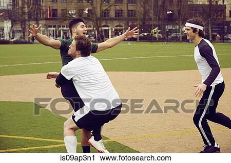 Three male soccer players celebrating on soccer pitch View Large Photo Image Stock Image - Three male soccer players celebrating on soccer pitch. Fotosearch