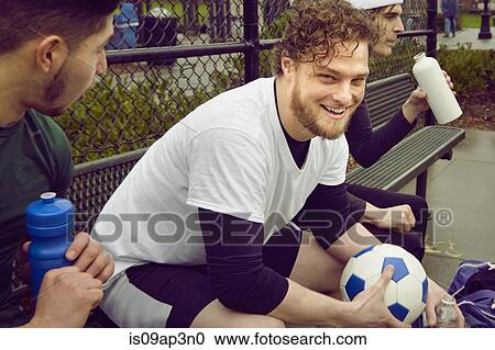 Three male soccer players taking a break View Large Photo Image Stock Image - Three male soccer players taking a break. Fotosearch