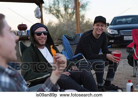 "Three young male friends sitting chatting on campsite, Anza-Borrego Desert State Park, California, USA" View Large Photo Image Stock Photography - "Three young male friends sitting chatting on campsite, Anza-Borrego Desert State Park, California, USA". Fotosearch