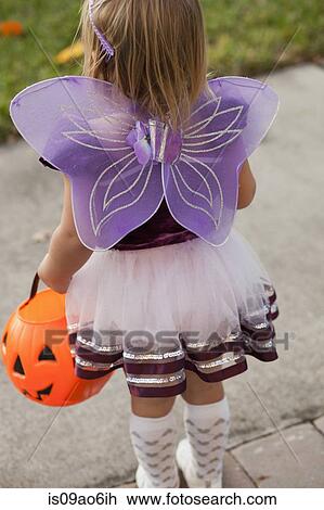 Toddler carrying Jack O' Lantern bucket View Large Photo Image Stock Image - Toddler carrying Jack O' Lantern bucket. Fotosearch