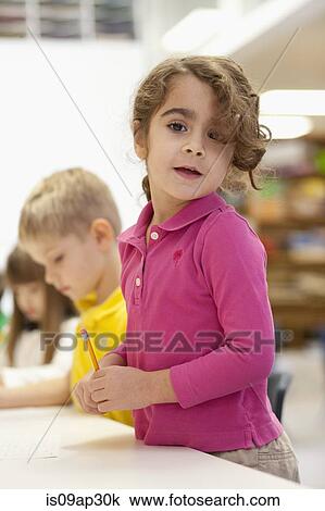 Toddler writing in classroom View Large Photo Image Stock Image - Toddler writing in classroom. Fotosearch