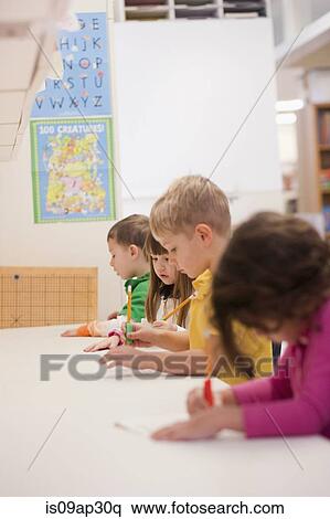Toddlers writing in classroom View Large Photo Image Stock Photography - Toddlers writing in classroom. Fotosearch