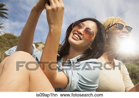 "Two female friends, outdoors, laughing together" View Large Photo Image Picture - "Two female friends, outdoors, laughing together". Fotosearch
