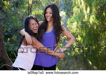 Two mid adult women fooling around in rural setting View Large Photo Image Stock Image - Two mid adult women fooling around in rural setting. Fotosearch