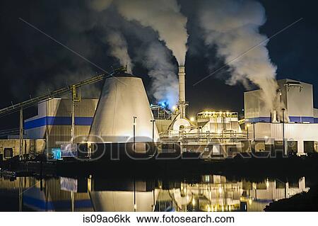 Stock Image - "View of pulp mill and smokestacks on waterfront at night, Strait of Juan de Fuca, Port Angeles, Washington State, USA". Fotosearch