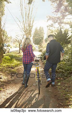 Young couple on path with bicycle View Large Photo Image Picture - Young couple on path with bicycle. Fotosearch