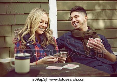 Young couple playing cards View Large Photo Image Stock Image - Young couple playing cards. Fotosearch