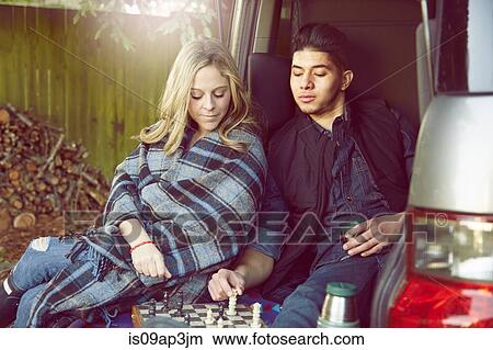 Picture - Young couple playing chess. Fotosearch