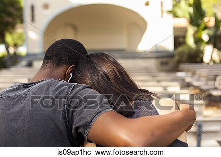 "Young couple sitting together, embracing, rear view" View Large Photo Image Stock Image - "Young couple sitting together, embracing, rear view". Fotosearch