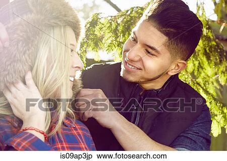 Stock Photography - "Young couple smiling, woman wearing hat". Fotosearch