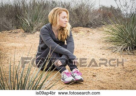 Young female runner sitting down and taking a break View Large Photo Image Stock Photography - Young female runner sitting down and taking a break. Fotosearch
