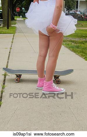 "Young girl standing next to skateboard, adjusting tutu, rear view, low section" View Large Photo Image Stock Image - "Young girl standing next to skateboard, adjusting tutu, rear view, low section". Fotosearch