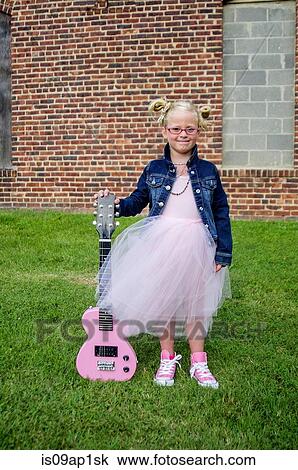"Young girl wearing tutu and denim jacket, holding guitar" View Large Photo Image Stock Image - "Young girl wearing tutu and denim jacket, holding guitar". Fotosearch